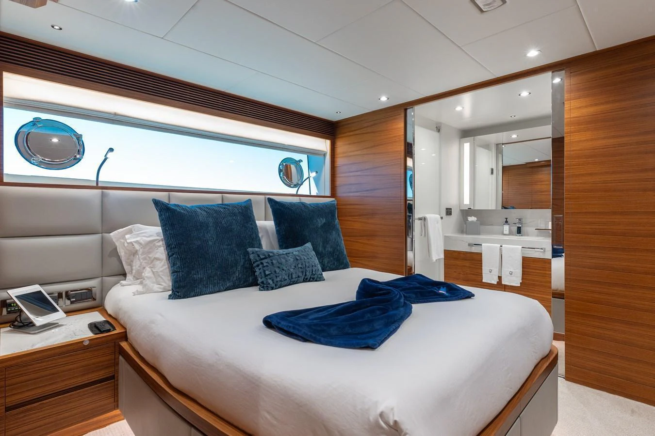 The master stateroom features a luxurious bed with plush pillows and elegant wood paneling. aboard NEX-T Yacht for Sale