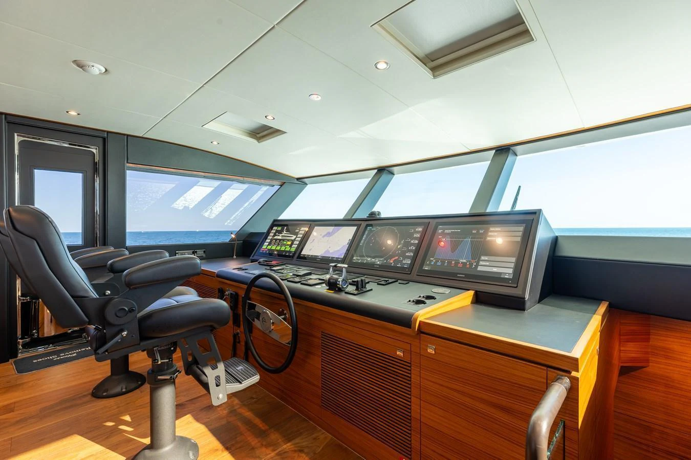 The helm station features advanced navigation equipment and luxurious seating, offering a commanding view of the sea. aboard NEX-T Yacht for Sale