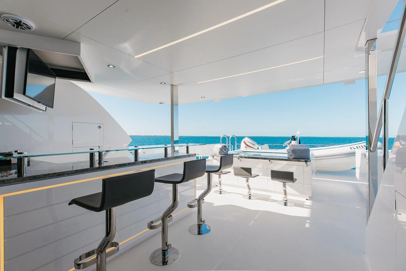The sundeck offers a luxurious open-air bar and seating area with stunning ocean views. aboard NEX-T Yacht for Sale