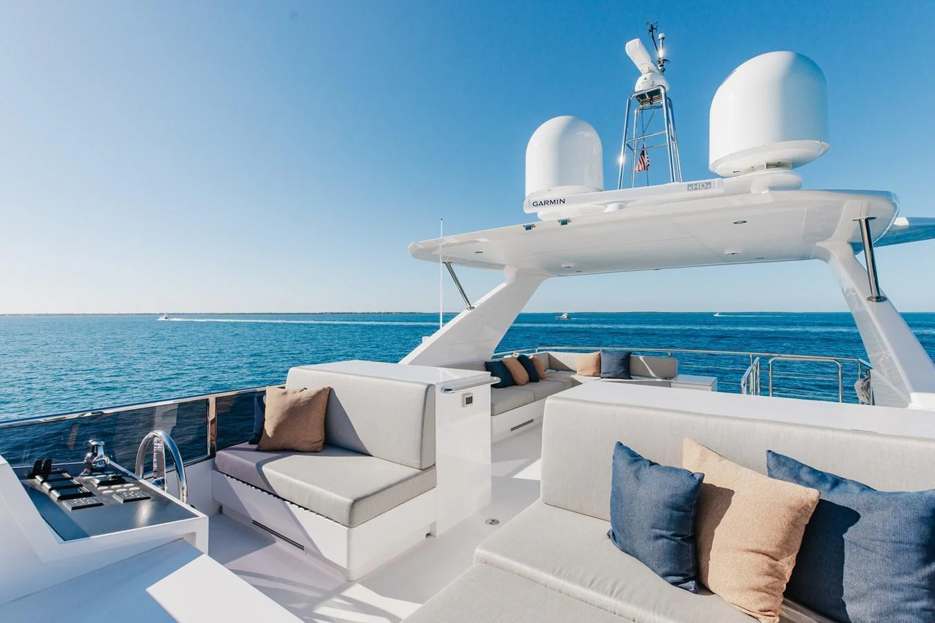 The flybridge offers ample seating with plush cushions and a stunning view of the open sea. aboard NEX-T Yacht for Sale