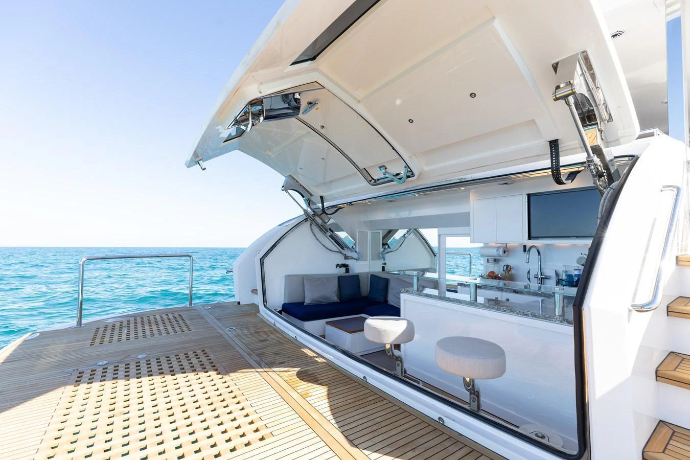 The yacht features a luxurious beach club with comfortable seating and a bar area, perfect for relaxation by the water. aboard NEX-T Yacht for Sale