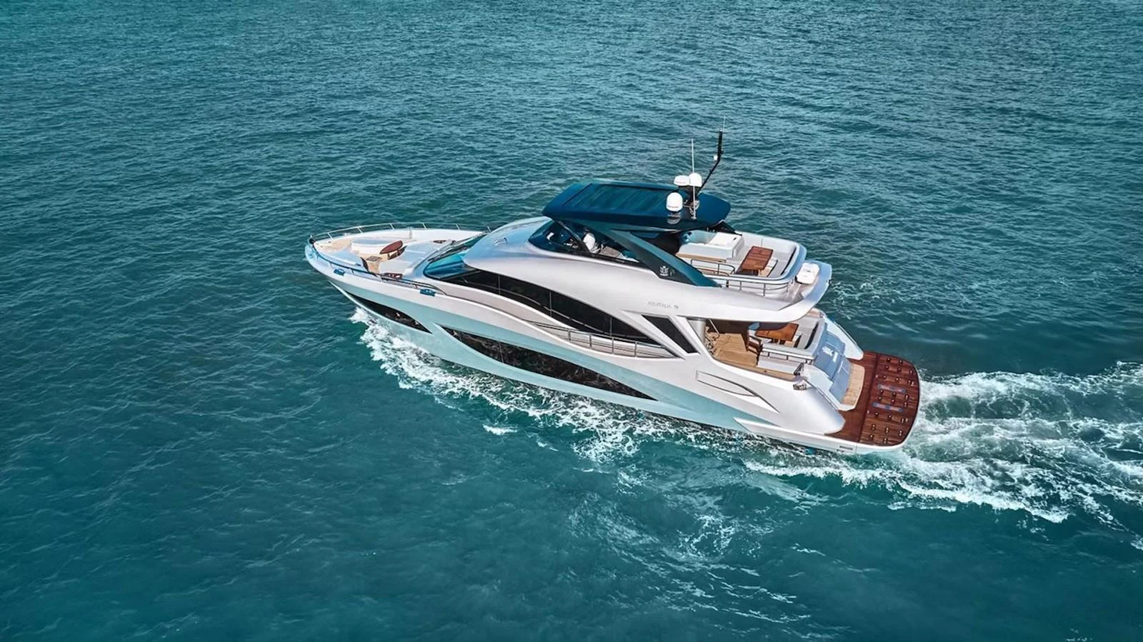 A sleek and modern yacht cruising through clear blue waters. aboard 7809 Yacht for Sale