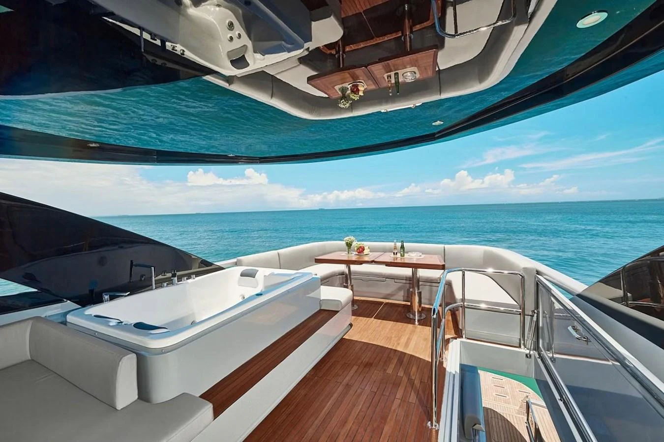 The sundeck offers a luxurious space with a jacuzzi, seating area, and stunning ocean views. aboard 7809 Yacht for Sale