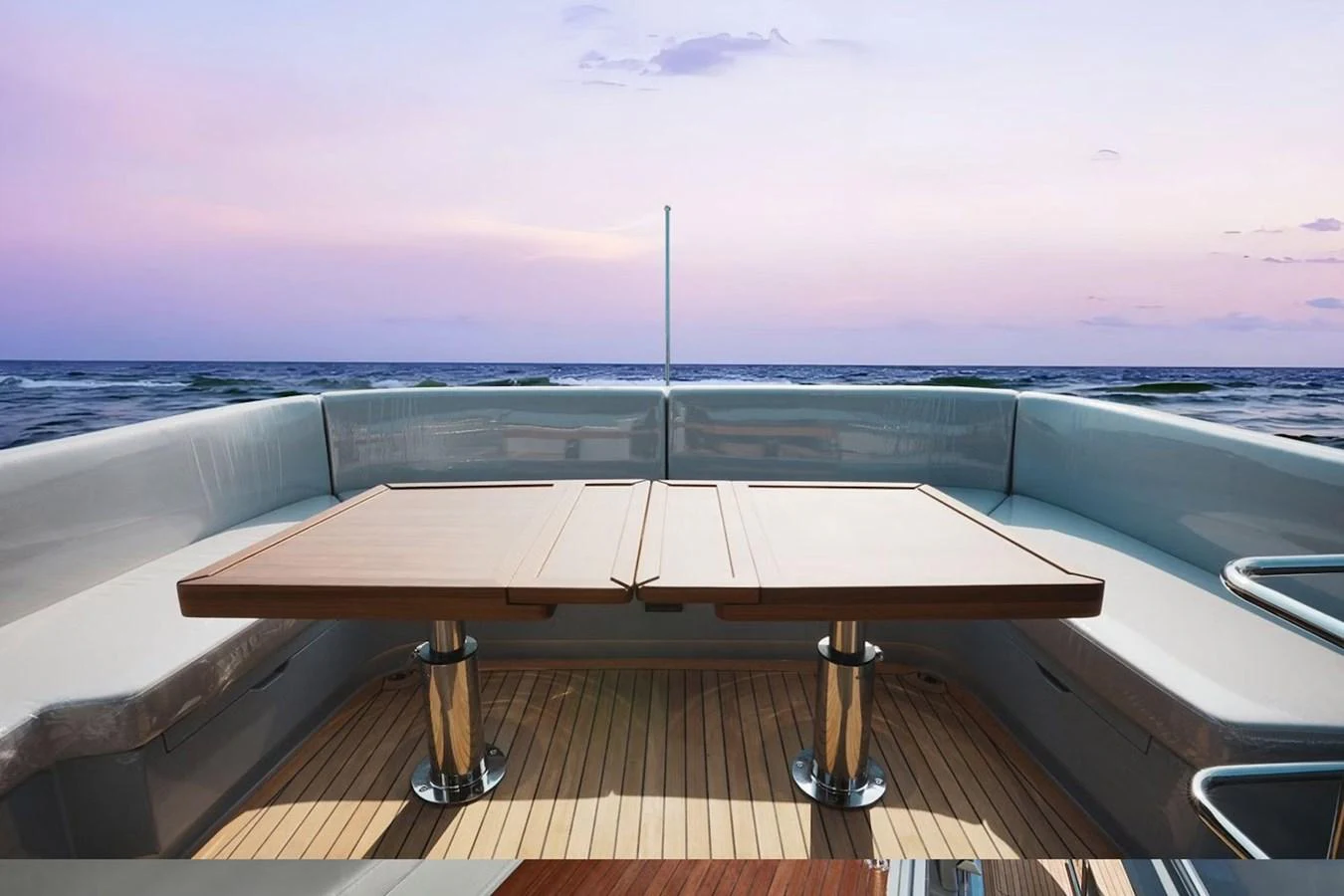 The aft deck features a stylish seating area with a wooden table, perfect for enjoying the ocean view. aboard 7809 Yacht for Sale