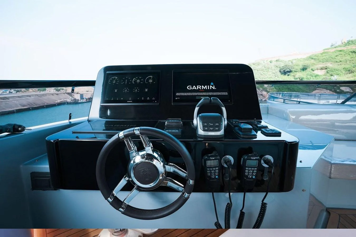 The helm station features advanced navigation equipment and a sleek steering wheel. aboard 7809 Yacht for Sale