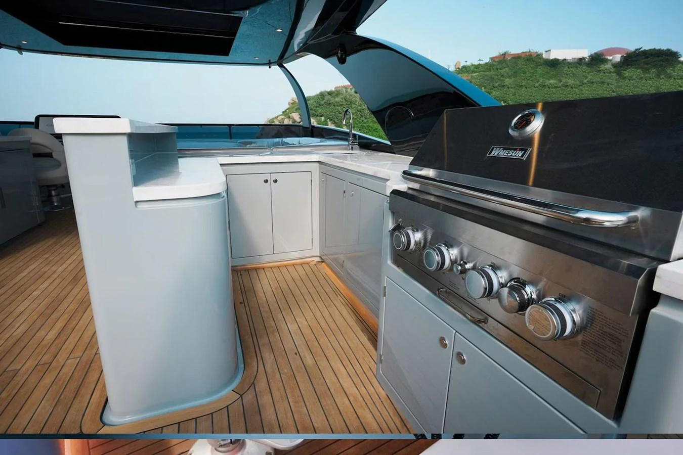 The yacht features a well-equipped outdoor galley with a grill and ample counter space, perfect for alfresco dining. aboard 7809 Yacht for Sale