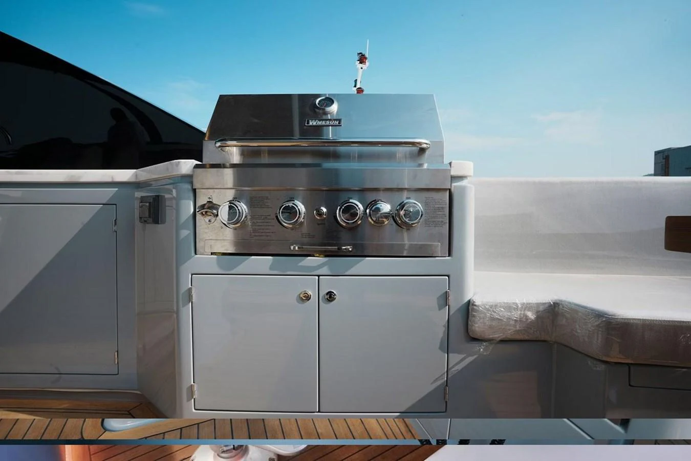 The yacht features a sleek and modern grill station, perfect for outdoor dining and entertaining. aboard 7809 Yacht for Sale