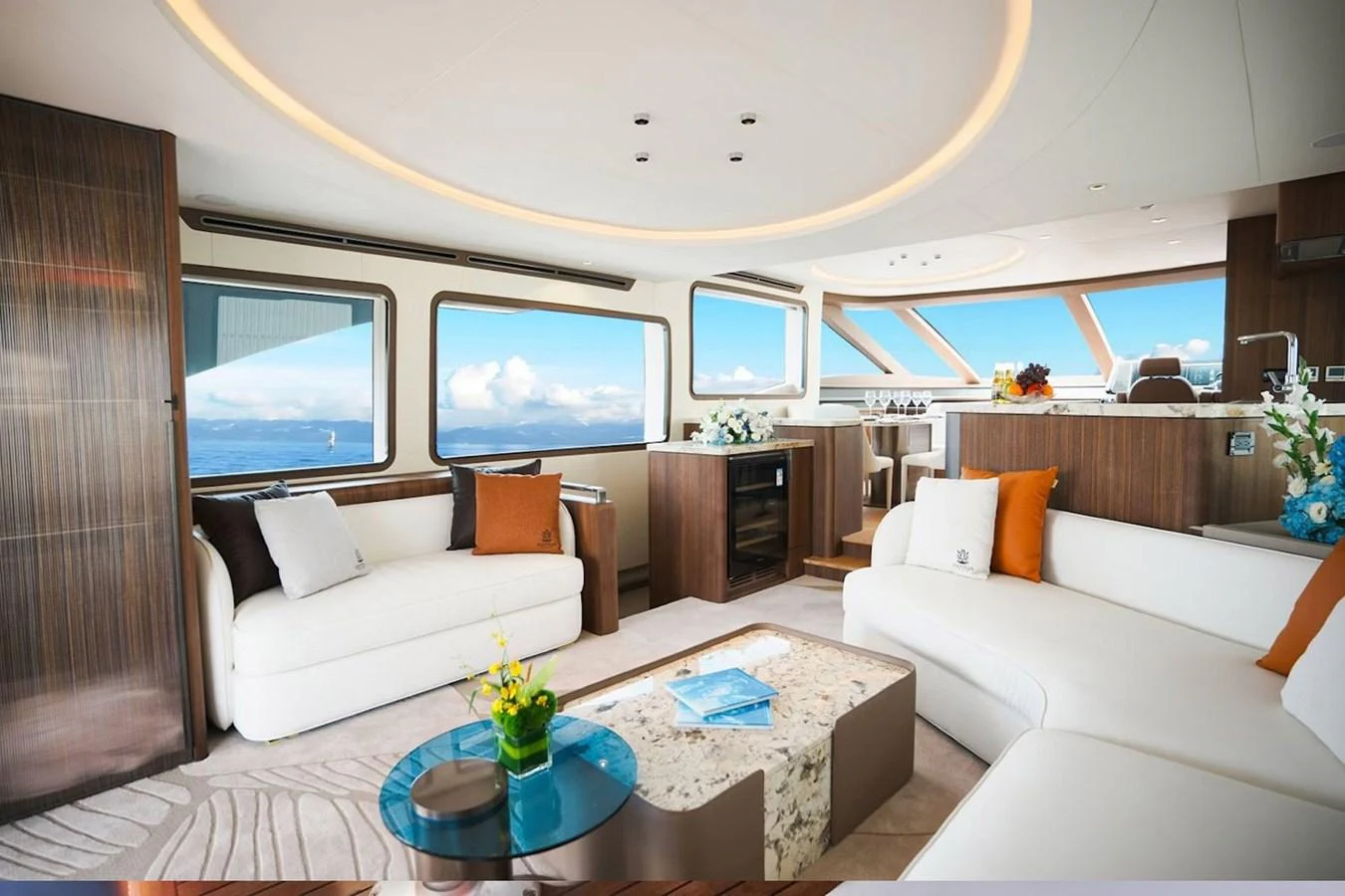 The salon features luxurious seating with panoramic windows offering stunning ocean views. aboard 7809 Yacht for Sale