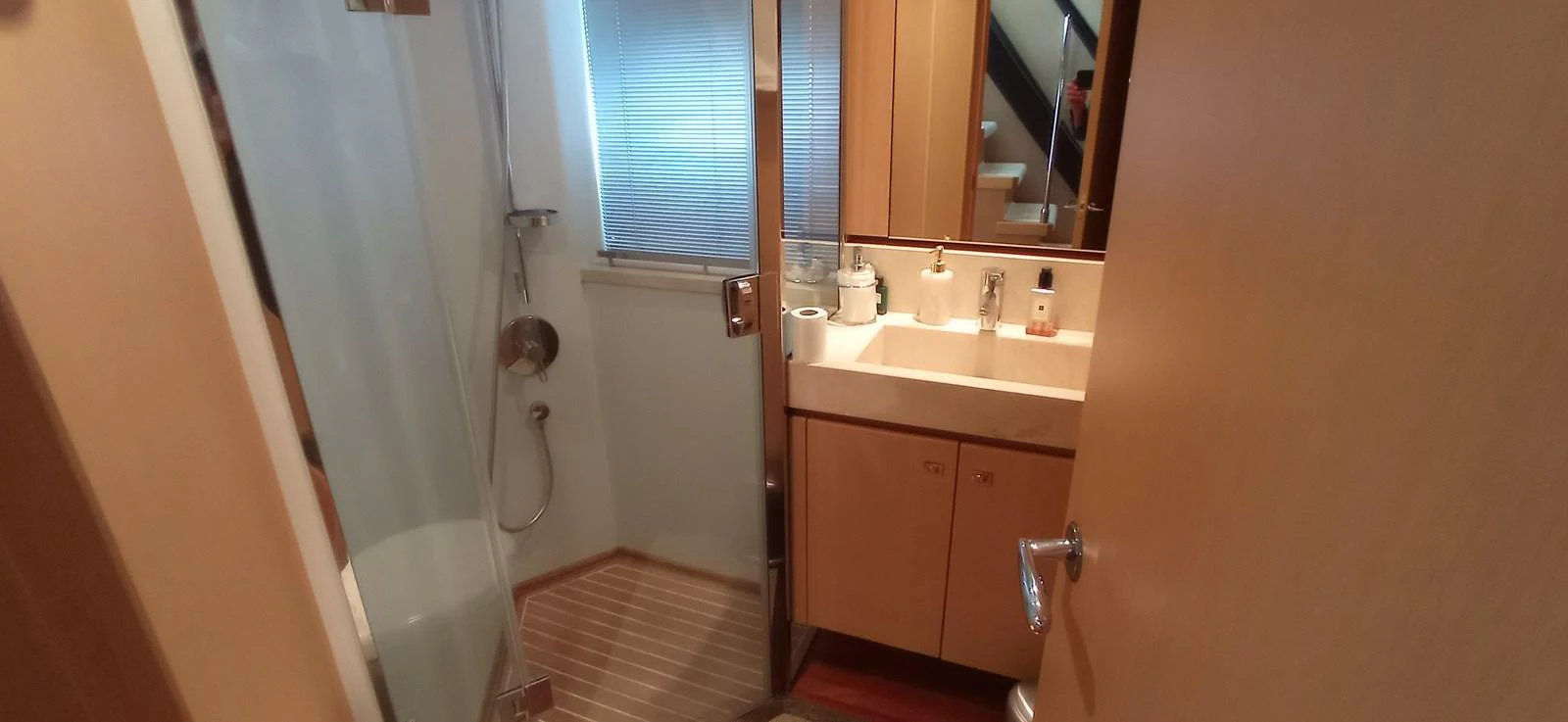 The yacht's bathroom features a sleek design with a glass shower enclosure and modern fixtures. aboard SFYFALL Yacht for Sale