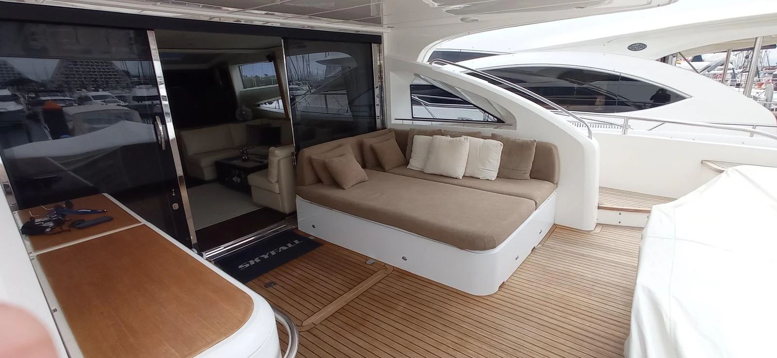 The aft deck features a spacious lounging area with comfortable seating and a sleek design. aboard SFYFALL Yacht for Sale