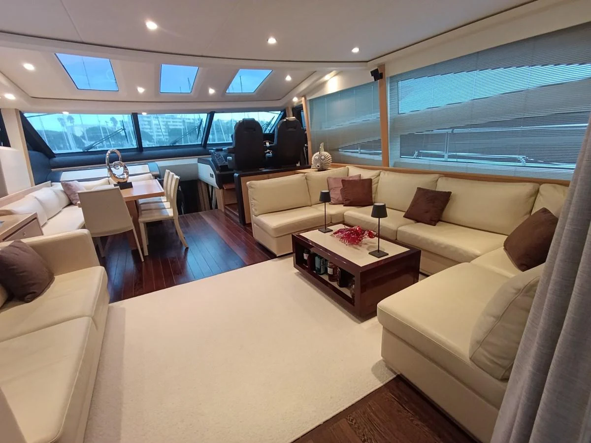 The yacht's salon features a spacious and elegant seating area with large windows and modern furnishings. aboard SFYFALL Yacht for Sale