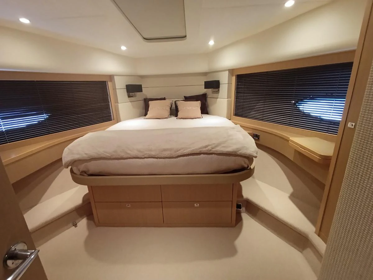 The master stateroom features a spacious bed with ample natural light from large windows. aboard SFYFALL Yacht for Sale