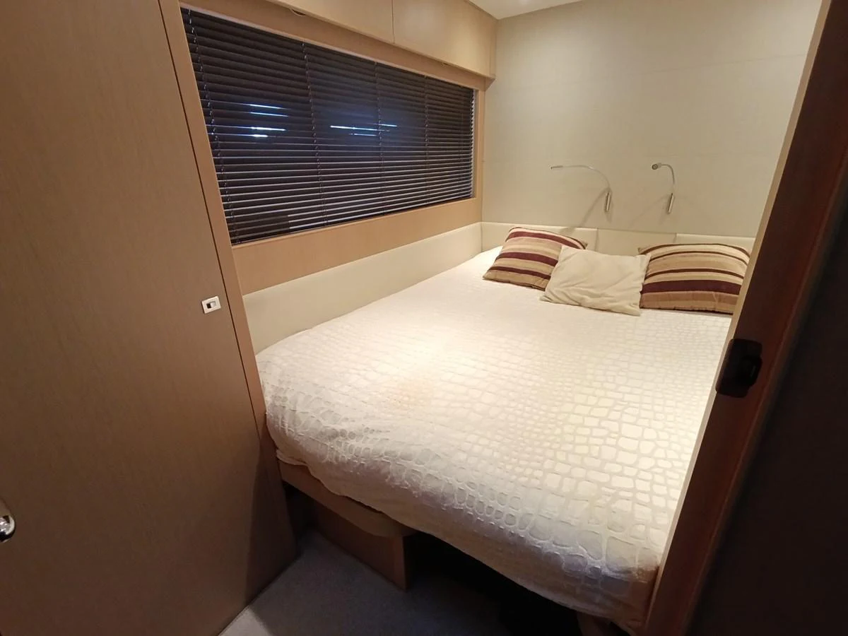 A cozy stateroom with a large bed and modern decor. aboard SFYFALL Yacht for Sale