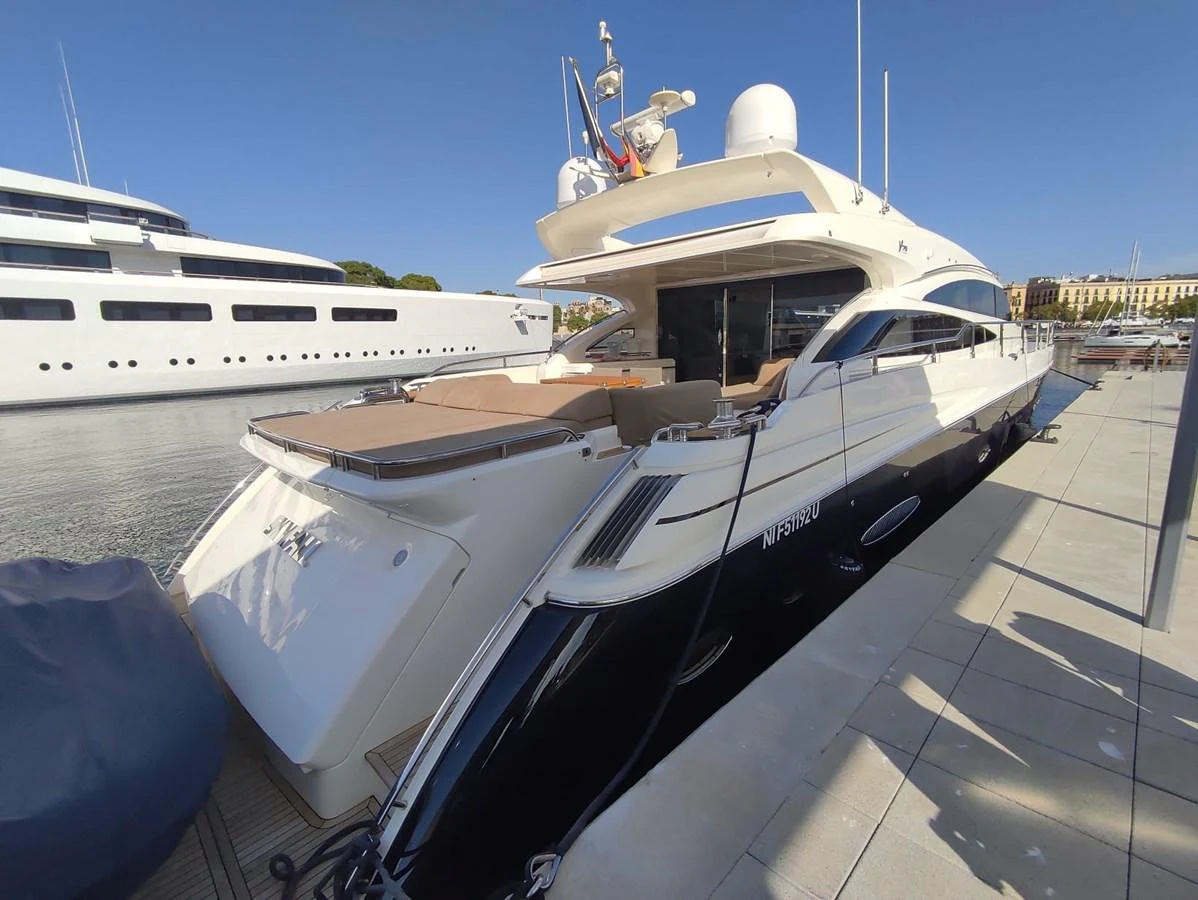 The yacht is docked, showcasing its sleek aft deck and modern design. aboard SFYFALL Yacht for Sale