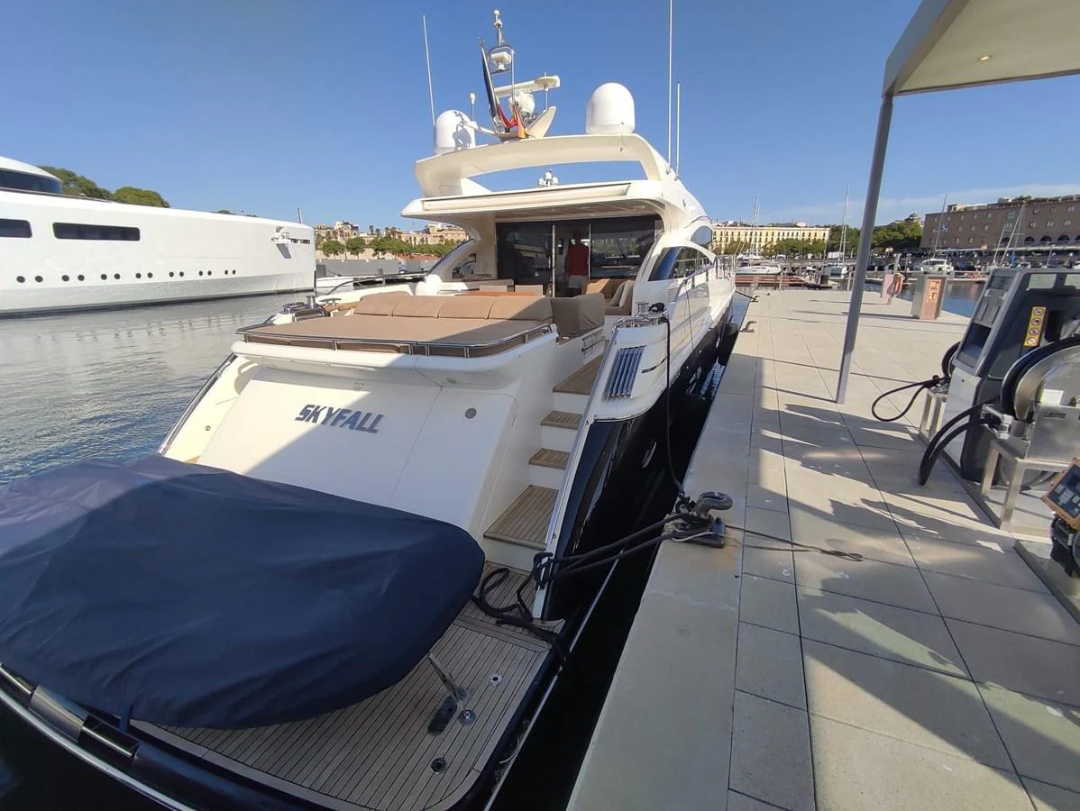 The yacht is docked at the marina, showcasing its sleek aft deck and luxurious design. aboard SFYFALL Yacht for Sale