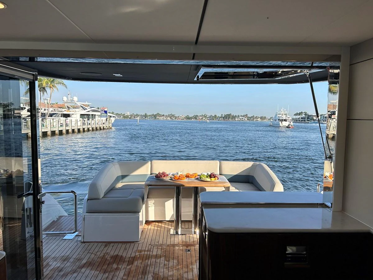 The aft deck offers a serene dining area with a stunning view of the water. aboard FAIRLINE SQUADRON Yacht for Sale