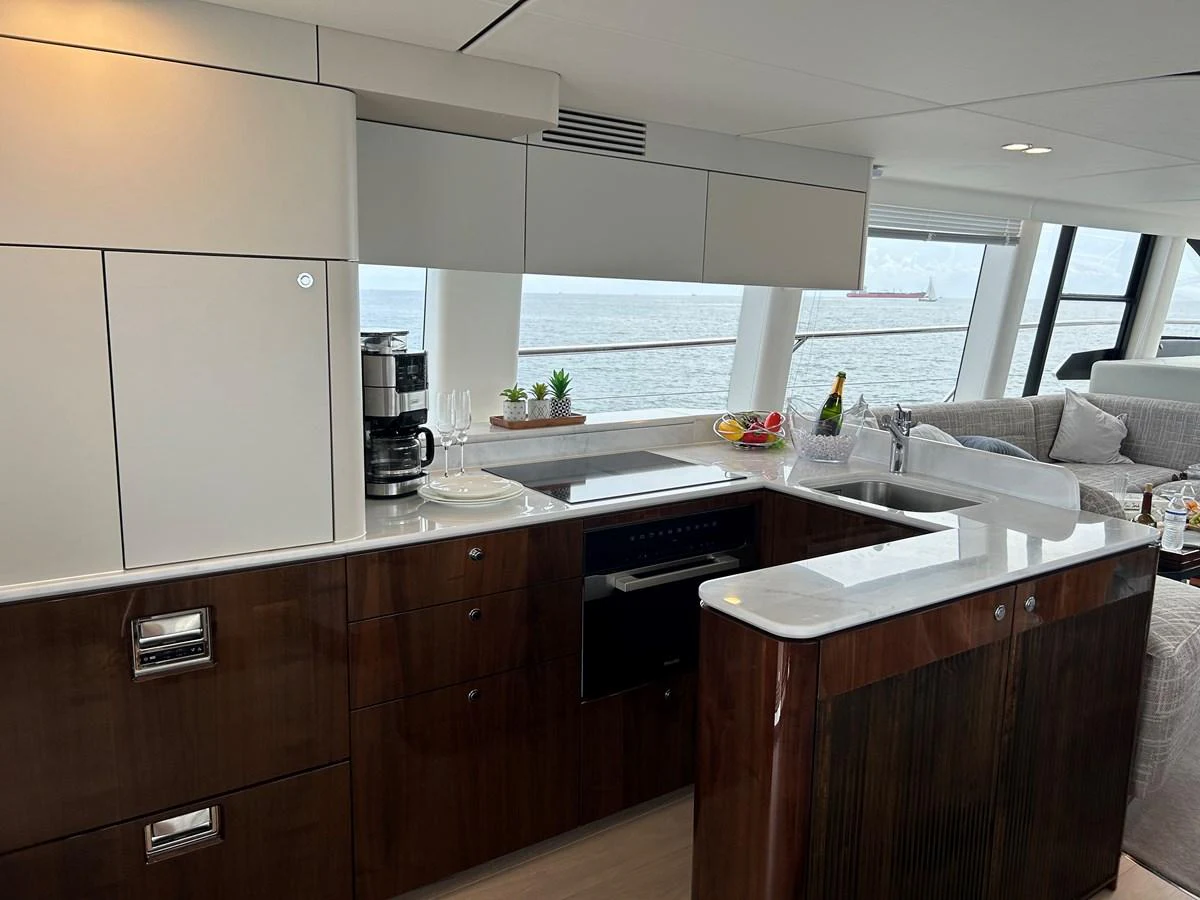 The yacht's galley features modern appliances and a sleek design with a view of the sea. aboard FAIRLINE SQUADRON Yacht for Sale