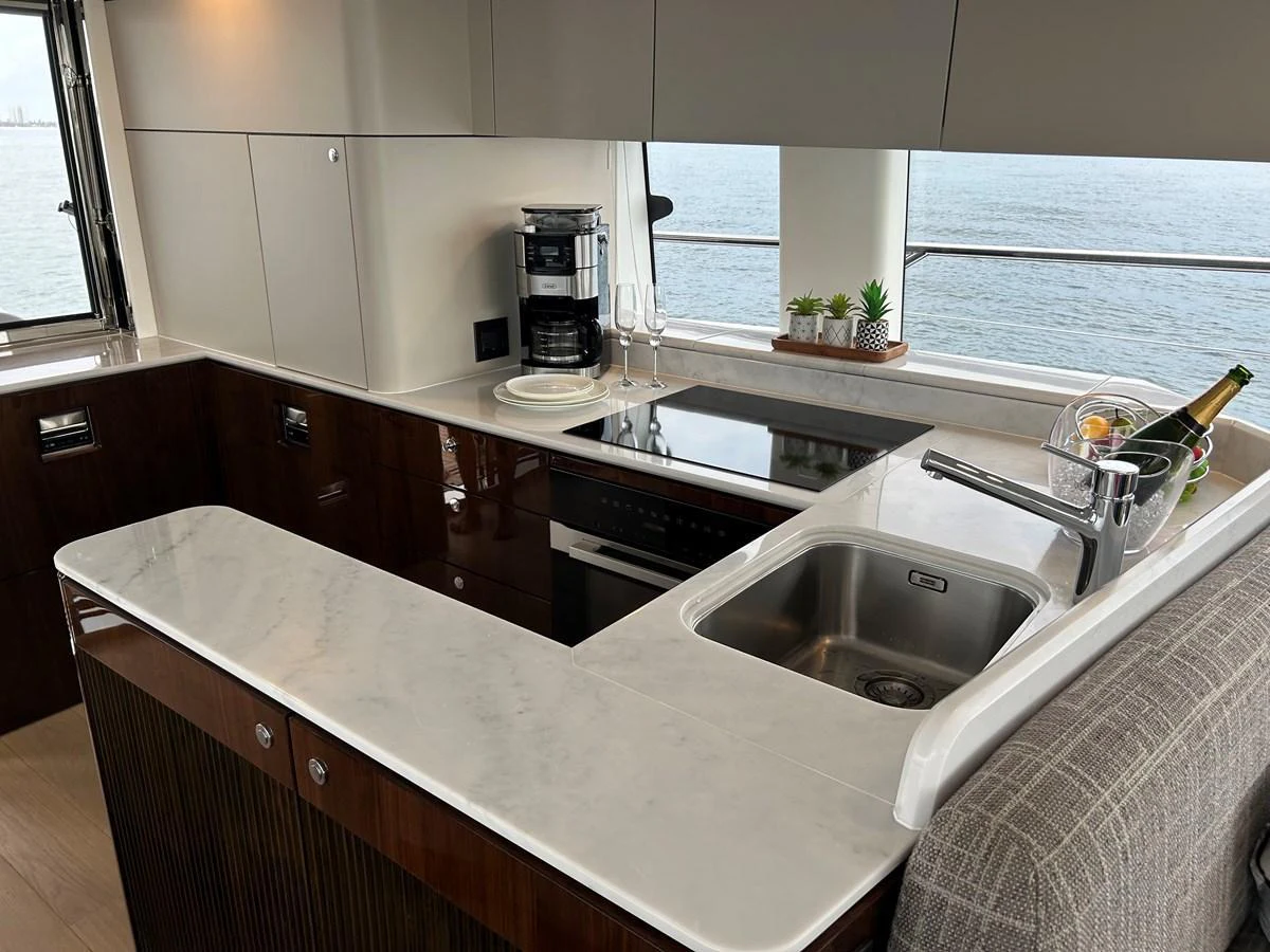 The yacht's galley features modern appliances and a sleek design with a view of the sea. aboard FAIRLINE SQUADRON Yacht for Sale