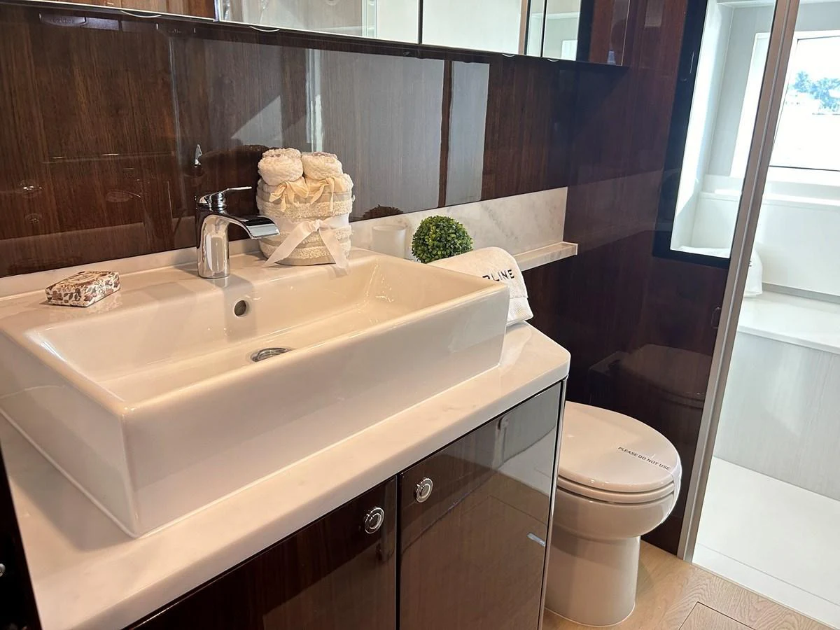 The yacht's bathroom features a sleek sink, modern fixtures, and a well-lit atmosphere. aboard FAIRLINE SQUADRON Yacht for Sale