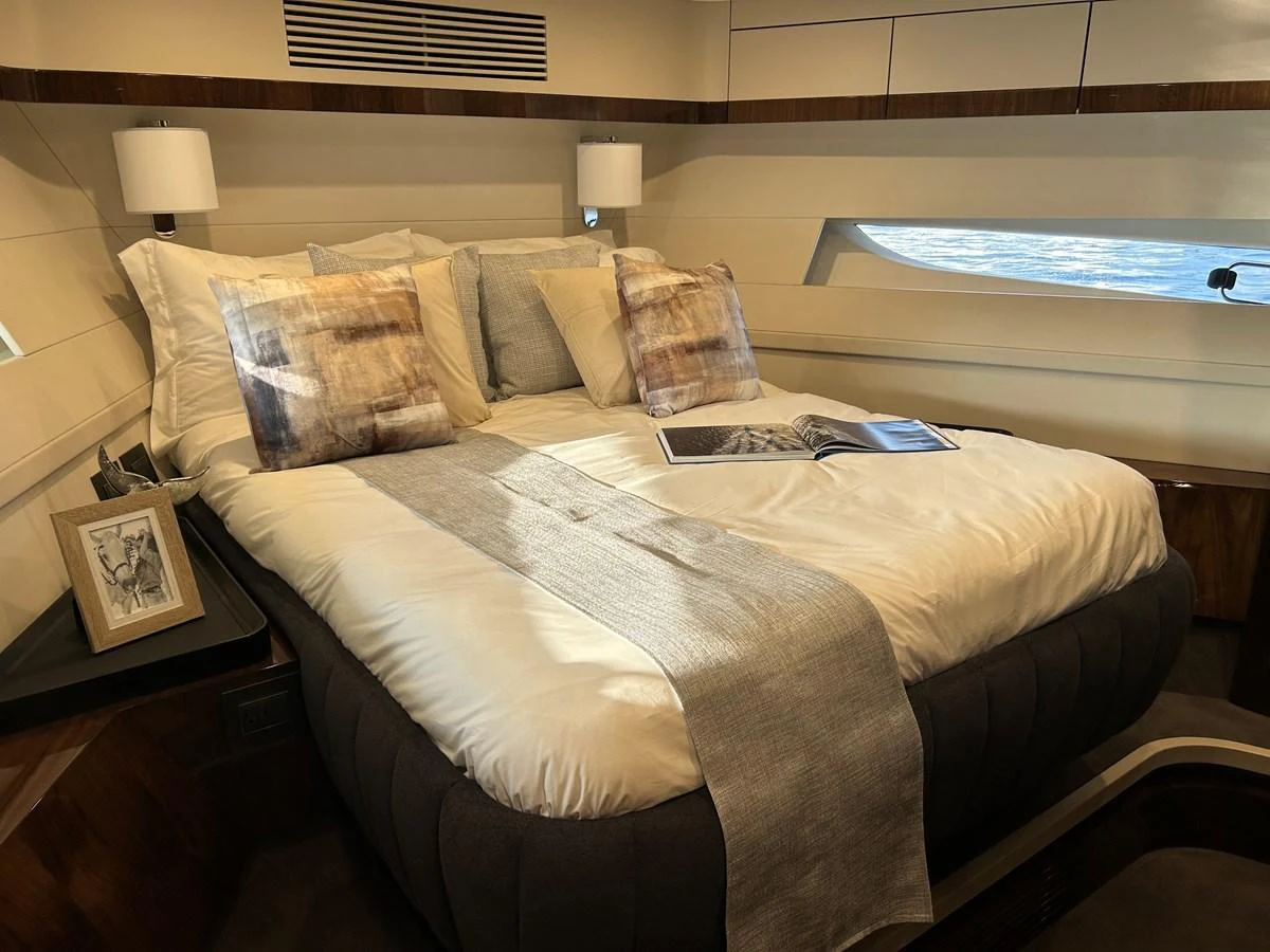A luxurious stateroom featuring a plush bed with elegant bedding and modern decor. aboard FAIRLINE SQUADRON Yacht for Sale