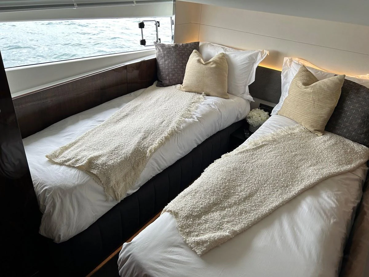 The twin stateroom offers a cozy and elegant sleeping arrangement with a view of the water. aboard FAIRLINE SQUADRON Yacht for Sale