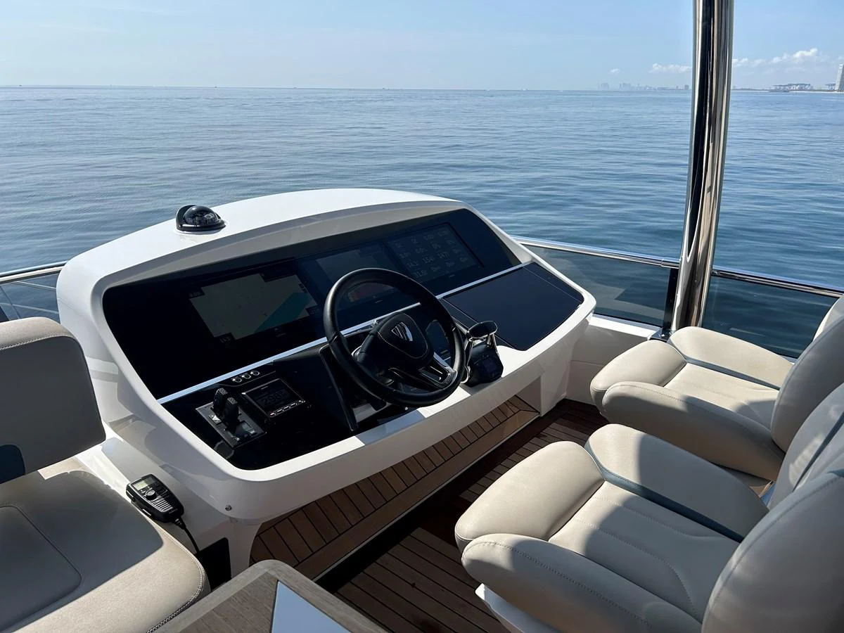 The helm station offers a commanding view of the open sea with modern navigation equipment and comfortable seating. aboard FAIRLINE SQUADRON Yacht for Sale