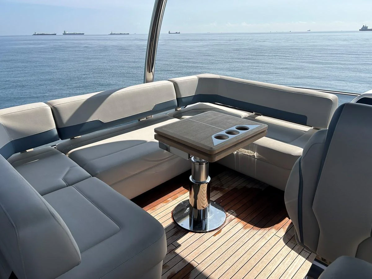 The aft deck features a comfortable seating area with a central table, perfect for enjoying the ocean view. aboard FAIRLINE SQUADRON Yacht for Sale