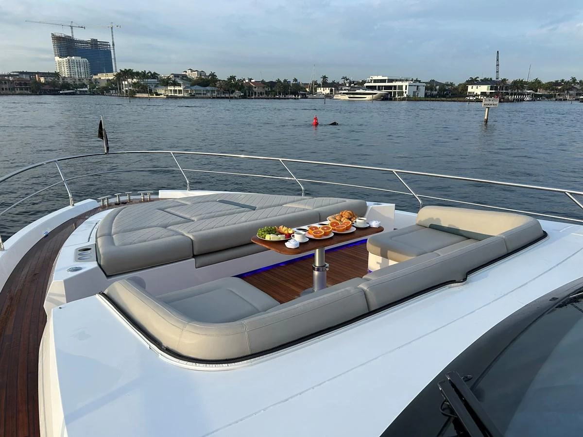 The foredeck features a spacious sunbathing area with comfortable seating and a table set for dining. aboard FAIRLINE SQUADRON Yacht for Sale