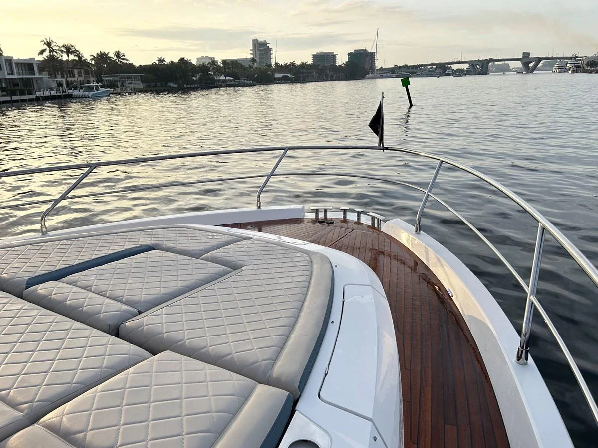 The bow of the yacht features a spacious sunpad with a scenic view of the water and city skyline. aboard FAIRLINE SQUADRON Yacht for Sale