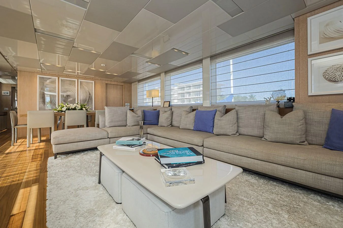 The salon features a spacious and elegant seating area with large windows providing ample natural light. aboard PERCAL Yacht for Sale