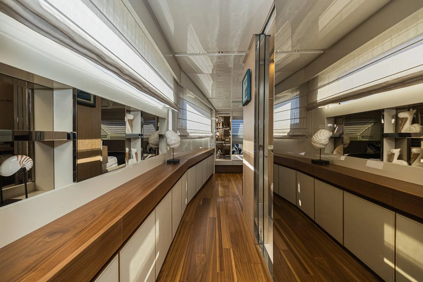 The yacht's interior features a sleek hallway with modern design elements and ample natural light. aboard PERCAL Yacht for Sale