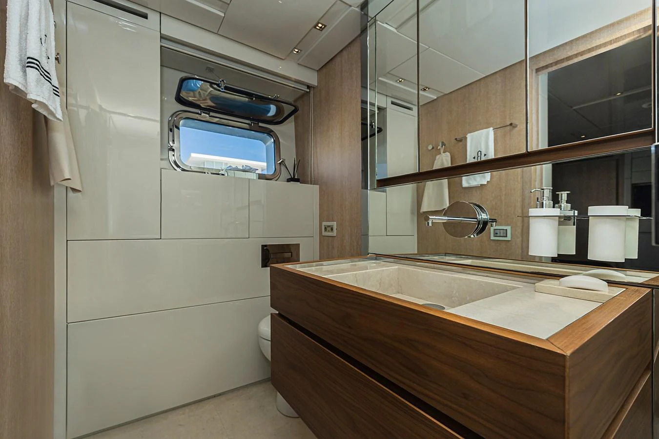 The yacht's bathroom features modern fixtures and a sleek design with ample storage and a large mirror. aboard PERCAL Yacht for Sale