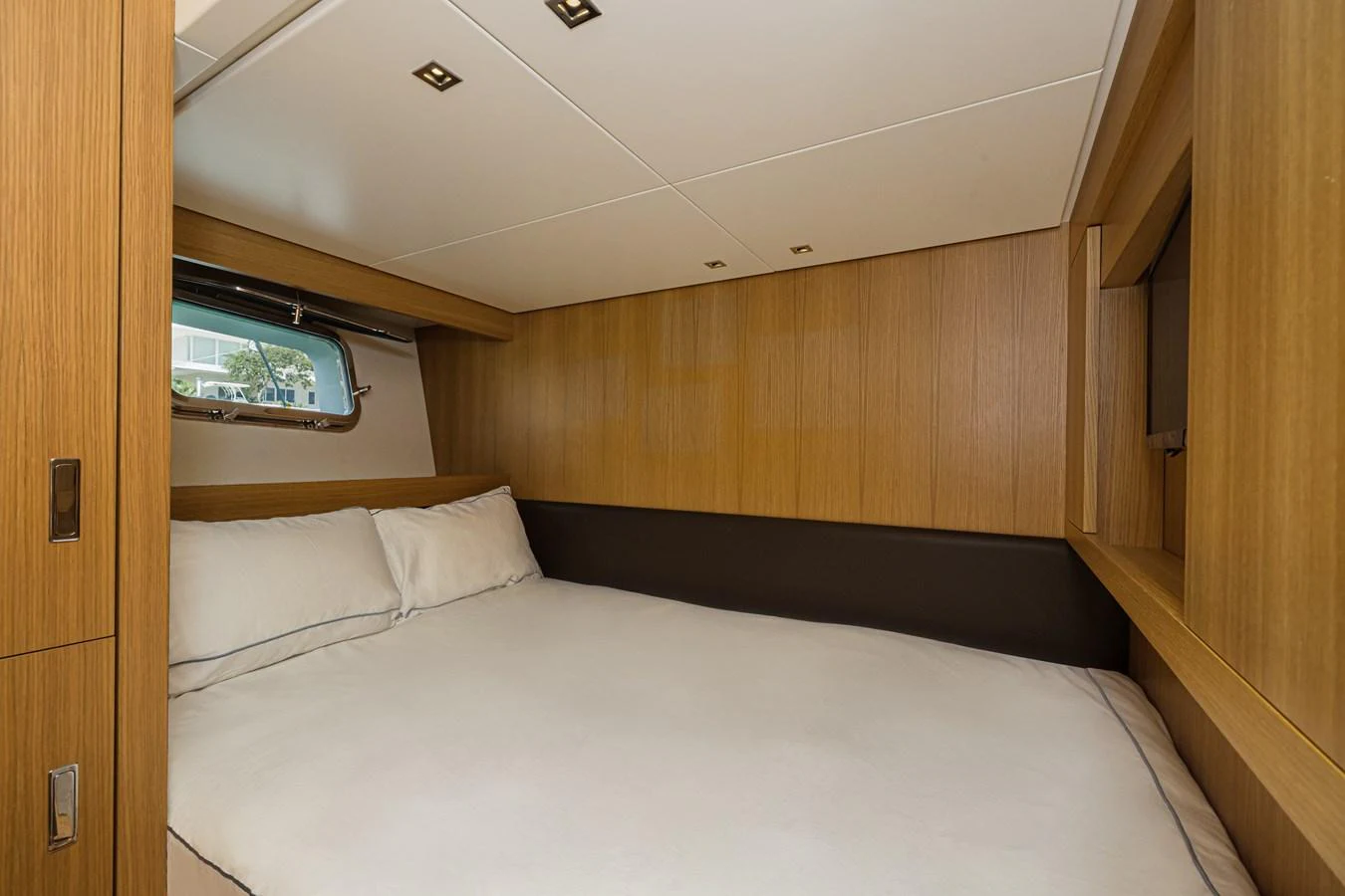 A cozy stateroom with a large bed and wooden paneling. aboard PERCAL Yacht for Sale