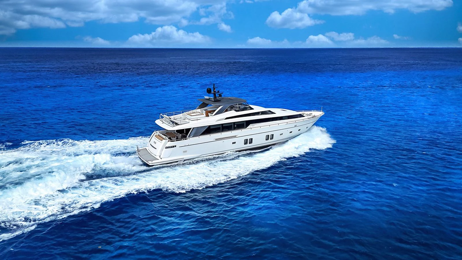 A sleek and modern yacht cruises through vibrant blue waters under a clear sky. aboard PERCAL Yacht for Sale
