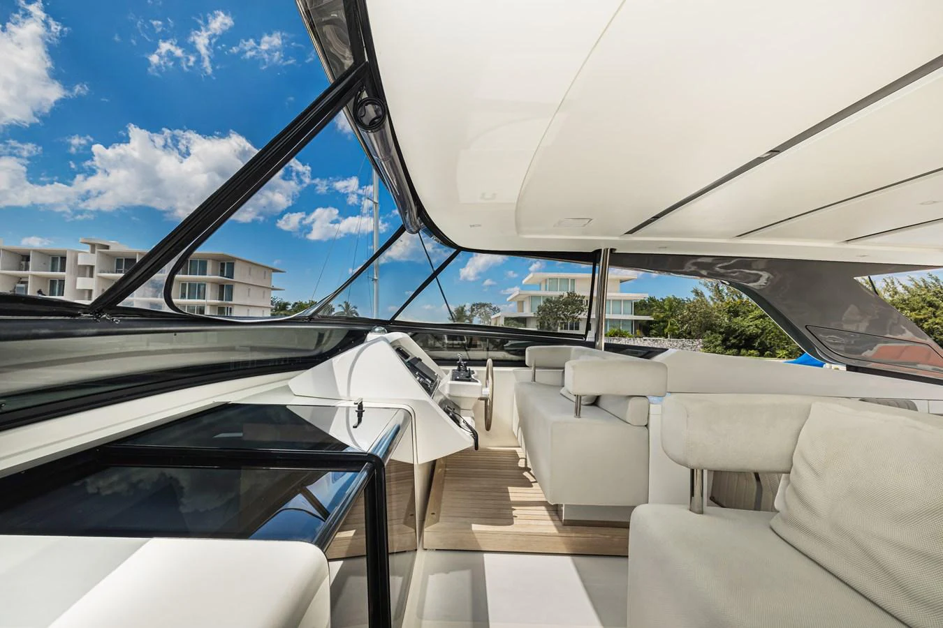 The helm area features modern seating and a sleek control panel under a large sunroof. aboard PERCAL Yacht for Sale