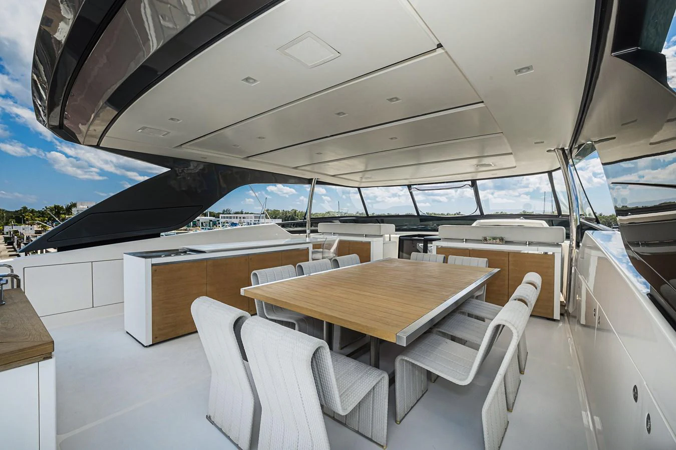 The aft deck features a spacious dining area with a large table and comfortable seating, perfect for alfresco meals. aboard PERCAL Yacht for Sale