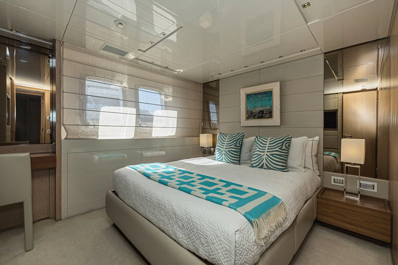 A luxurious stateroom featuring a large bed with stylish bedding and ample natural light from the windows. aboard PERCAL Yacht for Sale