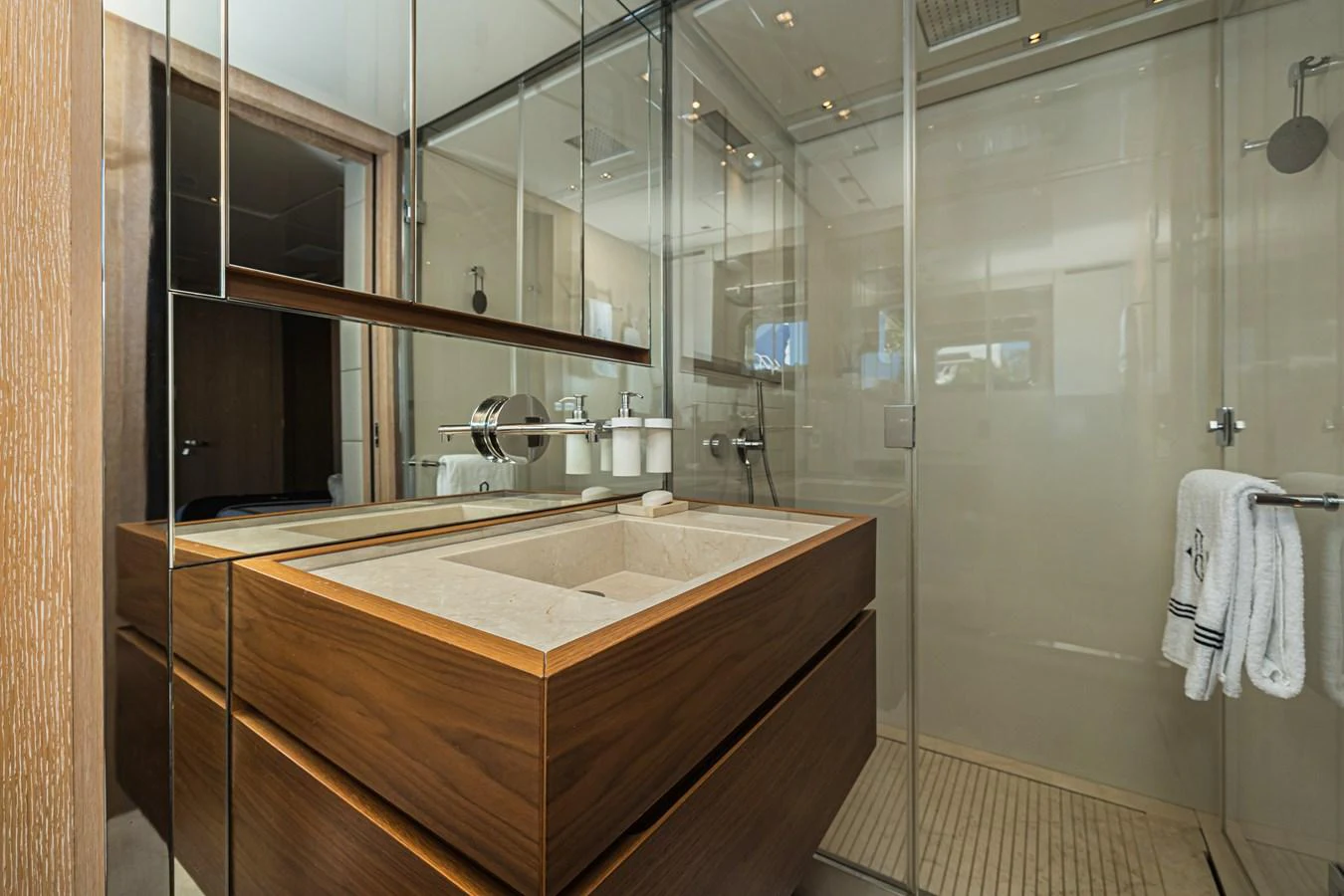 The yacht's bathroom features a modern design with a spacious shower and elegant wooden cabinetry. aboard PERCAL Yacht for Sale