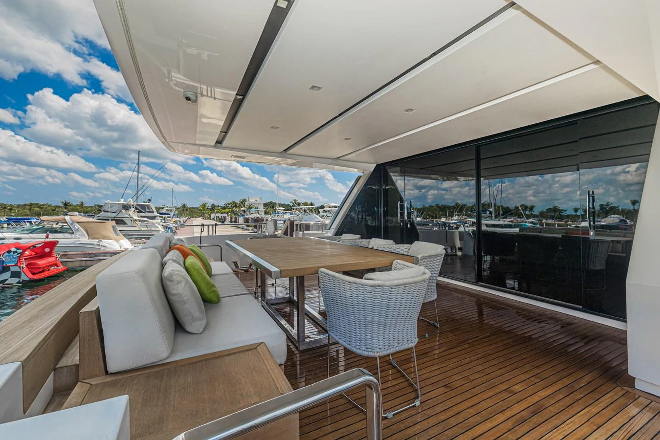 The aft deck features a comfortable seating area with a dining table, perfect for alfresco dining. aboard PERCAL Yacht for Sale