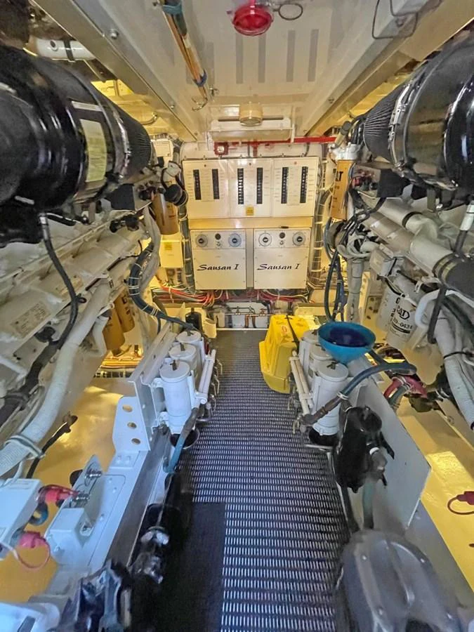 The image showcases the yacht's well-maintained engine room with advanced machinery and equipment. aboard HATTERAS 68 CONVERTIBLE Yacht for Sale