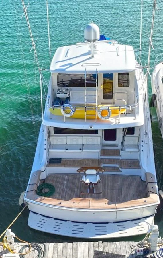 The yacht's aft deck offers a spacious and inviting area for relaxation and entertainment. aboard HATTERAS 68 CONVERTIBLE Yacht for Sale
