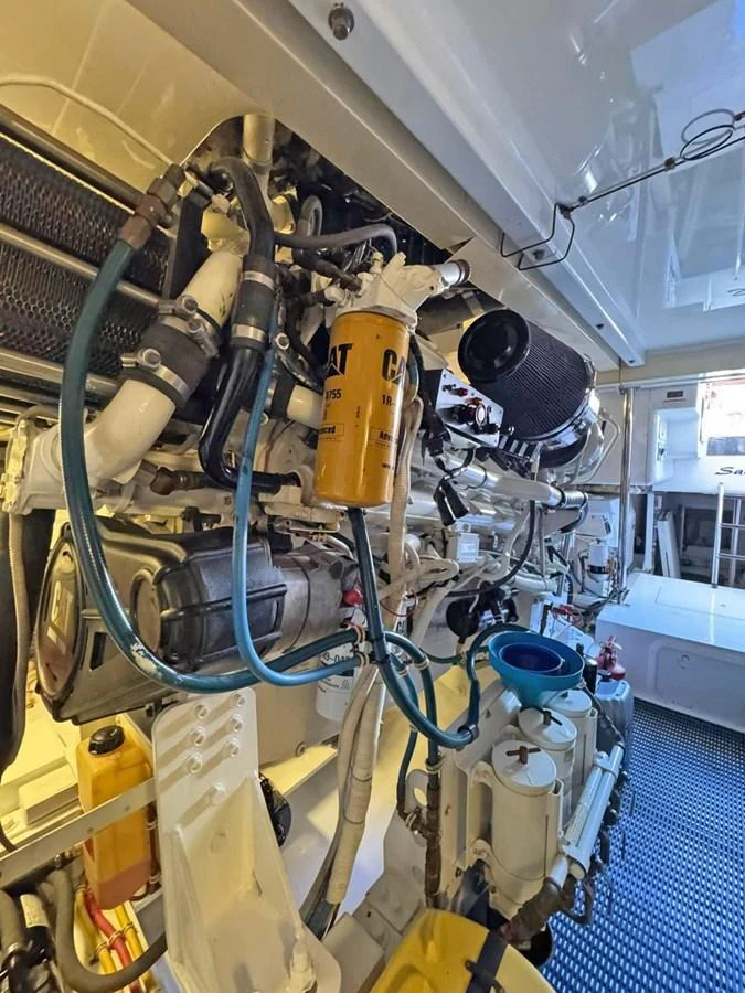The yacht's engine room showcases its complex machinery and systems. aboard HATTERAS 68 CONVERTIBLE Yacht for Sale