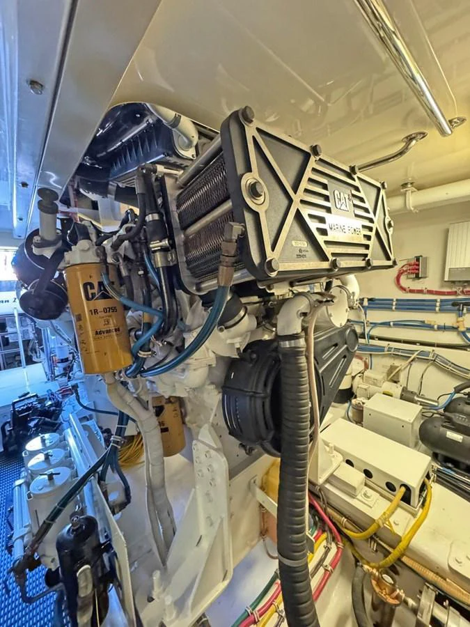 The image showcases the intricate details of the yacht's engine room, highlighting the advanced machinery and components. aboard HATTERAS 68 CONVERTIBLE Yacht for Sale