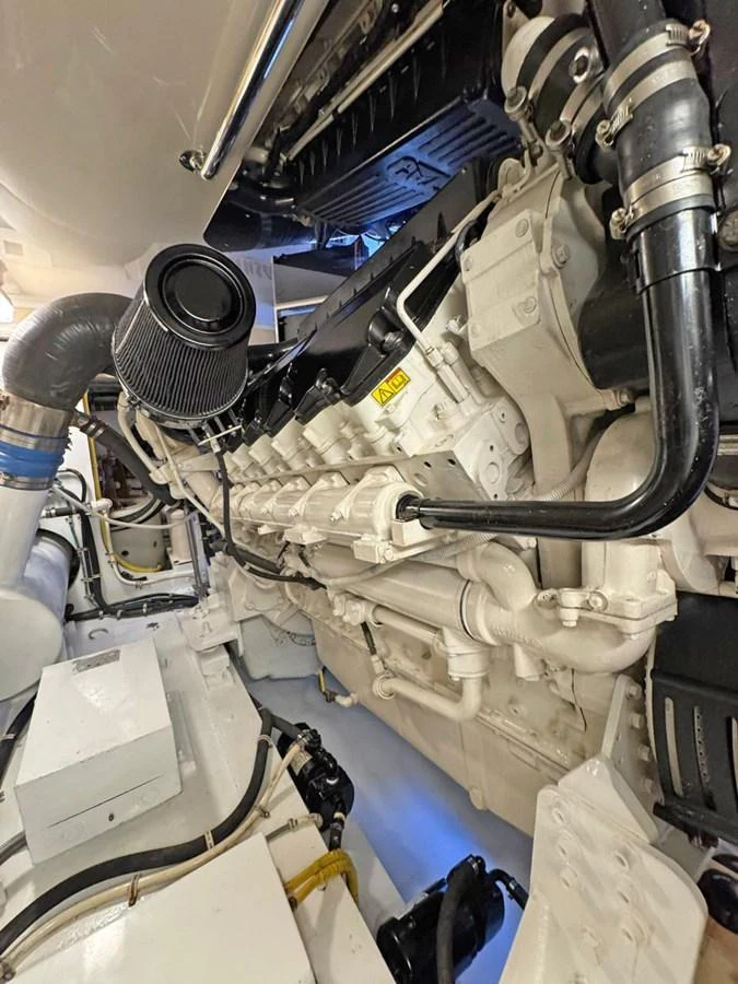 The image showcases the yacht's meticulously maintained engine room with powerful machinery. aboard HATTERAS 68 CONVERTIBLE Yacht for Sale