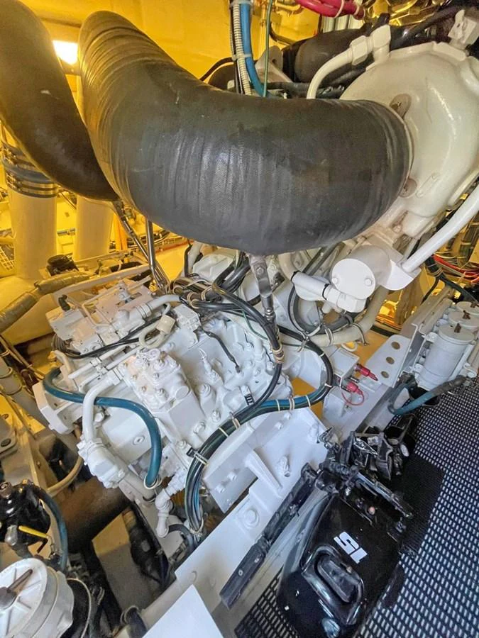 The image showcases the intricate machinery within the yacht's engine room. aboard HATTERAS 68 CONVERTIBLE Yacht for Sale