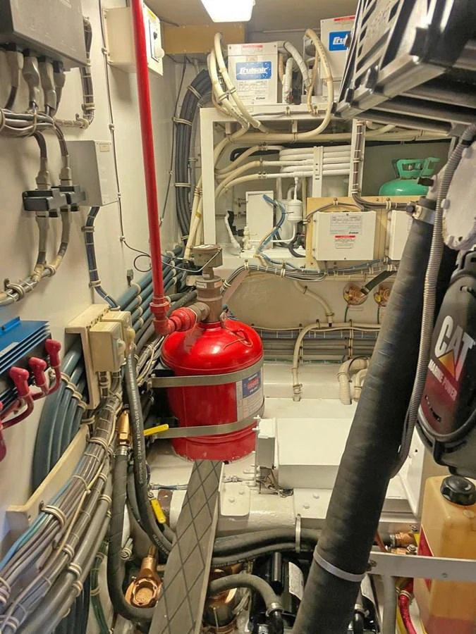 The image showcases the intricate and well-organized engine room of the yacht. aboard HATTERAS 68 CONVERTIBLE Yacht for Sale