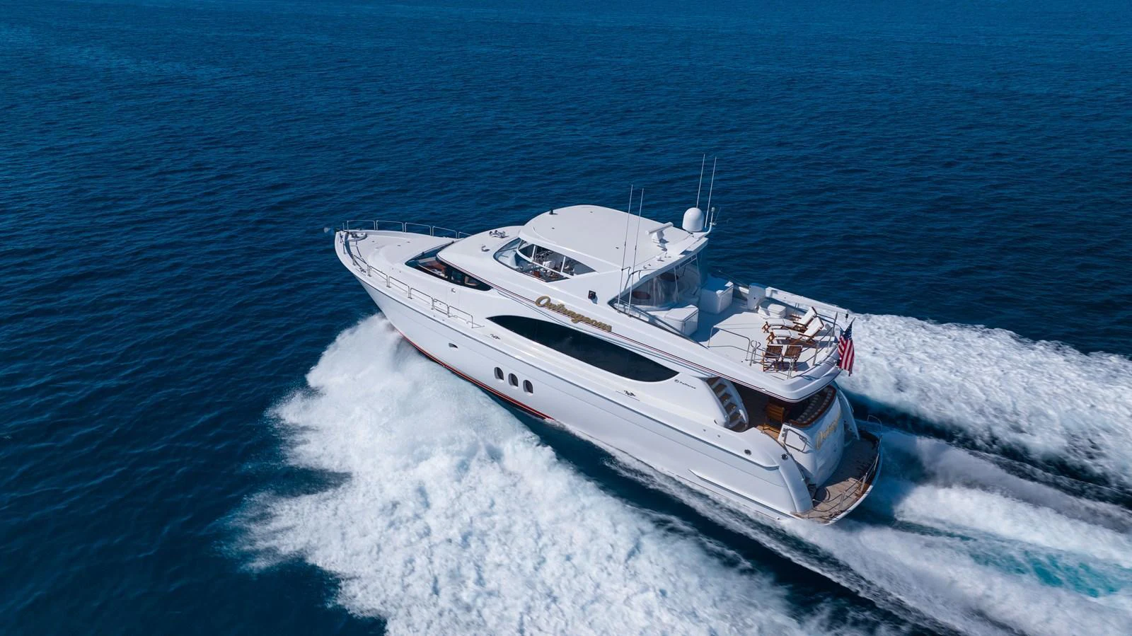 A sleek and modern yacht cruises swiftly through the open sea, showcasing its elegant design and powerful performance. aboard OUTRAGEOUS Yacht for Sale