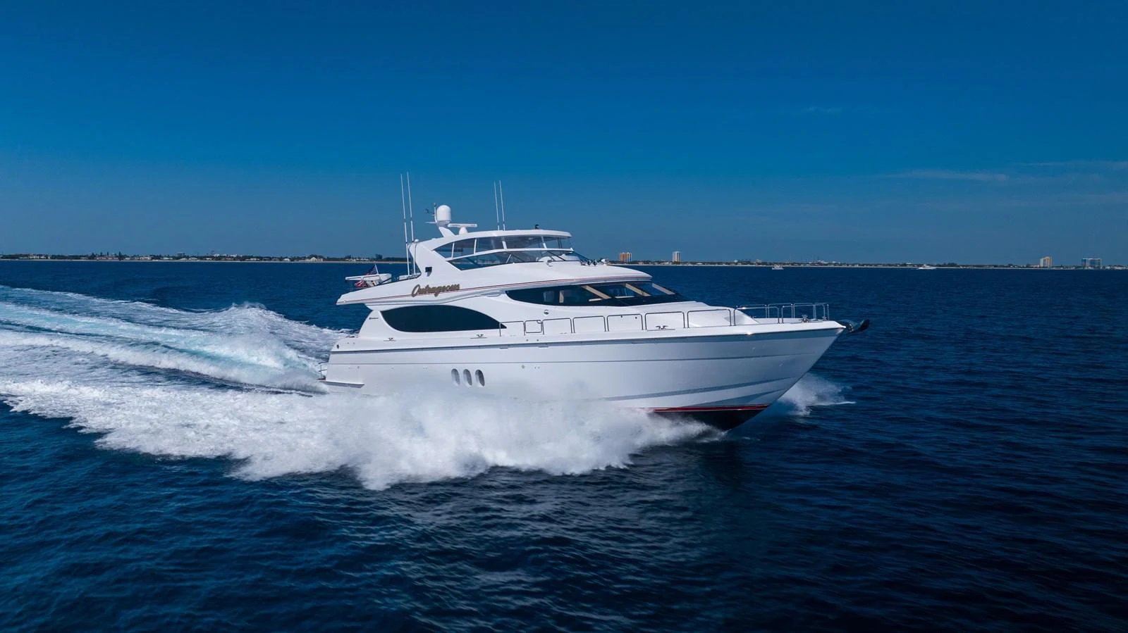 A sleek yacht cruises swiftly through the open water, showcasing its elegant design and powerful performance. aboard OUTRAGEOUS Yacht for Sale