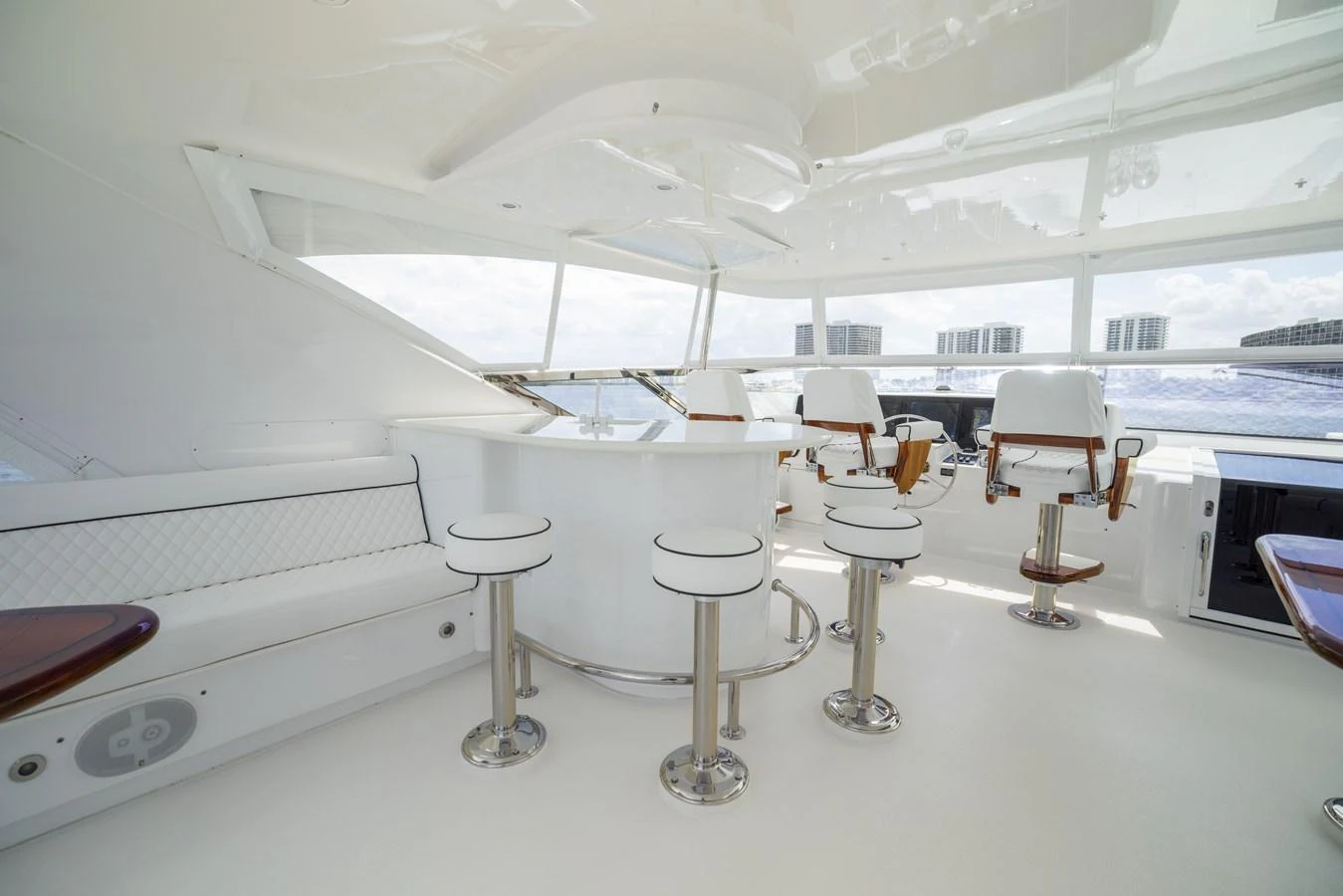 The helm area features a sleek, modern design with comfortable seating and panoramic views. aboard OUTRAGEOUS Yacht for Sale