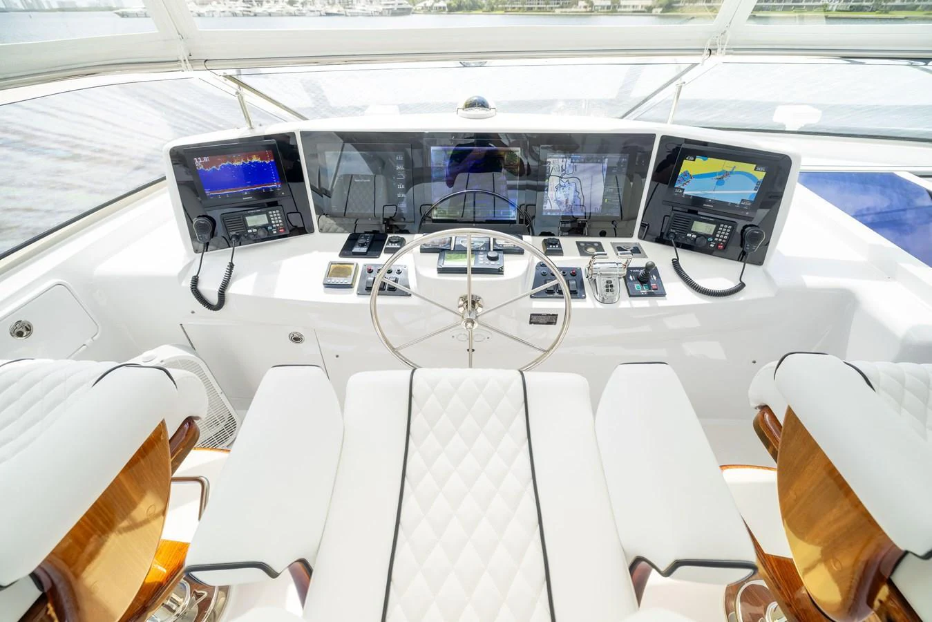 The helm station features state-of-the-art navigation equipment and luxurious seating. aboard OUTRAGEOUS Yacht for Sale